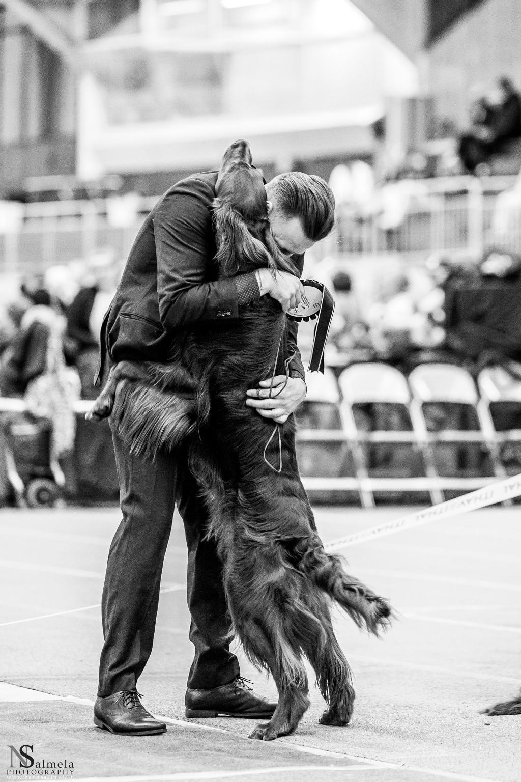 A person hugging a dog

Description automatically generated